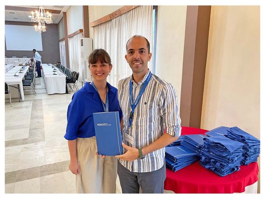 Two people holding a folder in front of them