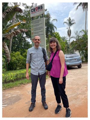 Two persons standing in front of the entry of the centre